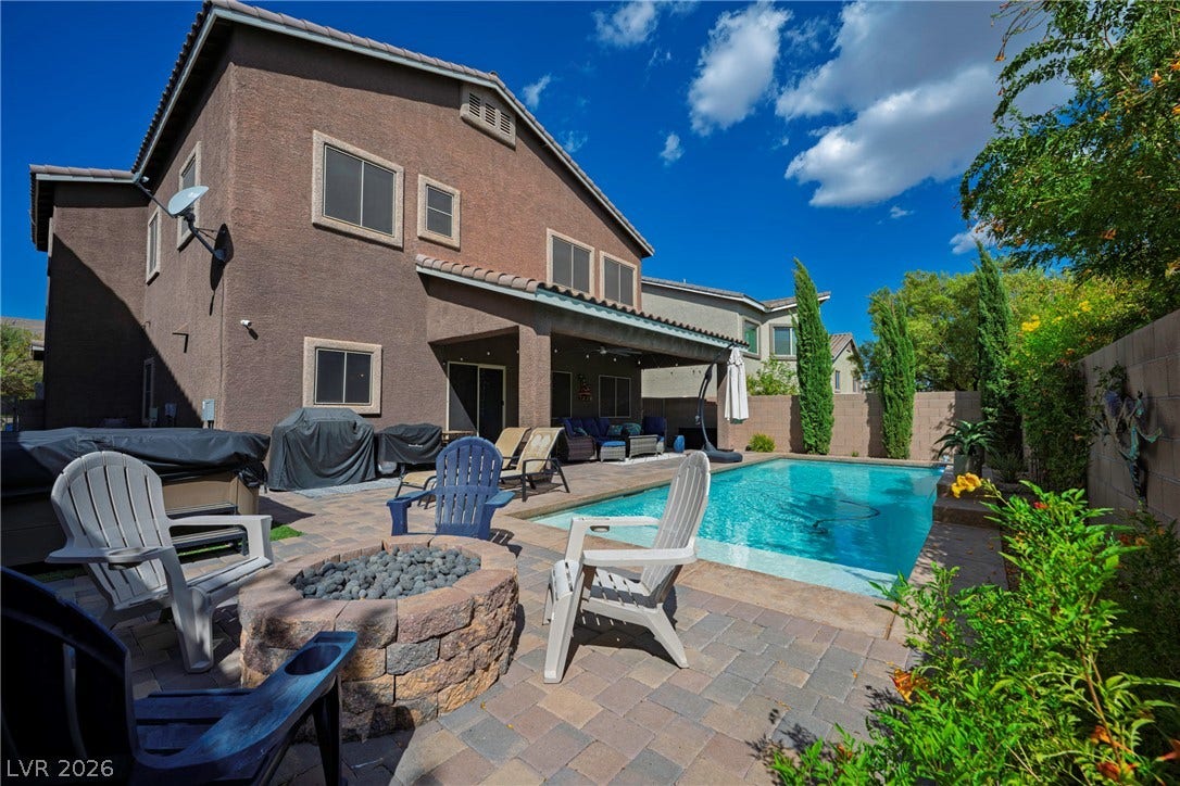 152 Dunblane Street, Henderson, NV 89012 A sparkling in-ground pool and stone fire pit highlight this private outdoor retreat.
