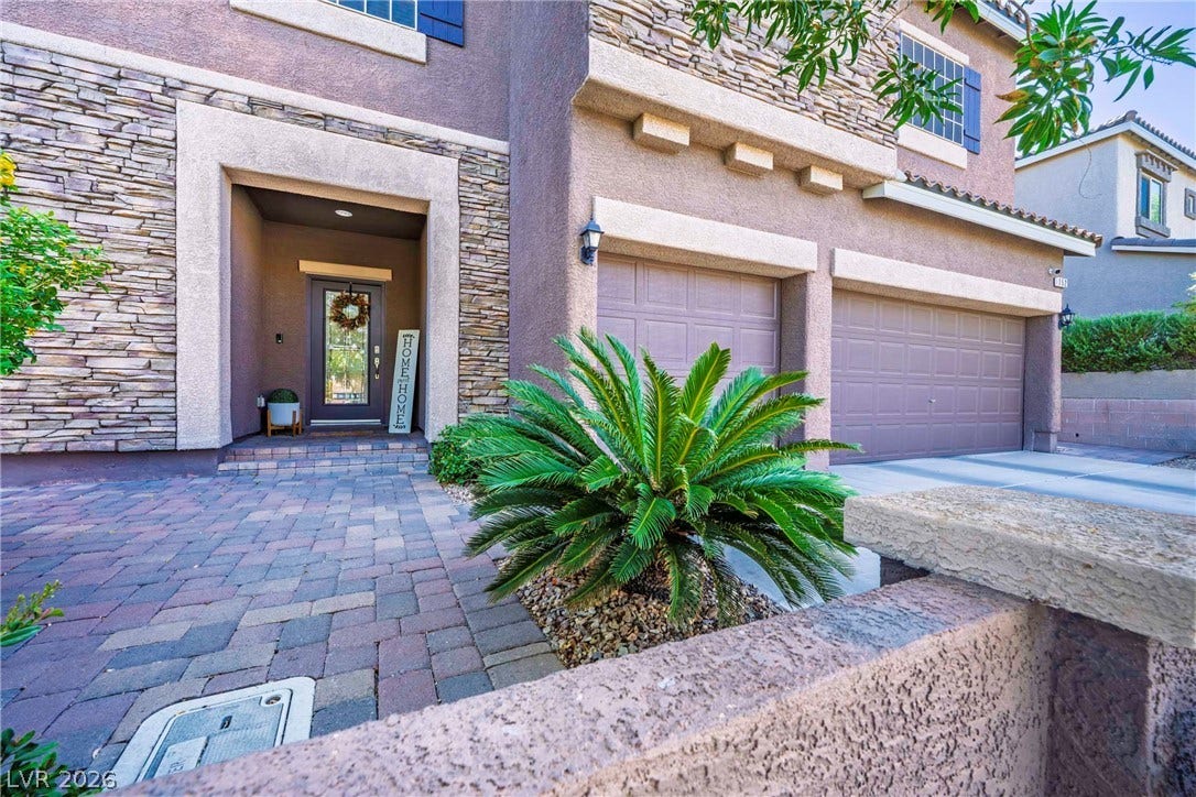 152 Dunblane Street, Henderson, NV 89012 Stone accents and a paved path enhance the exterior of this multi-car garage home.