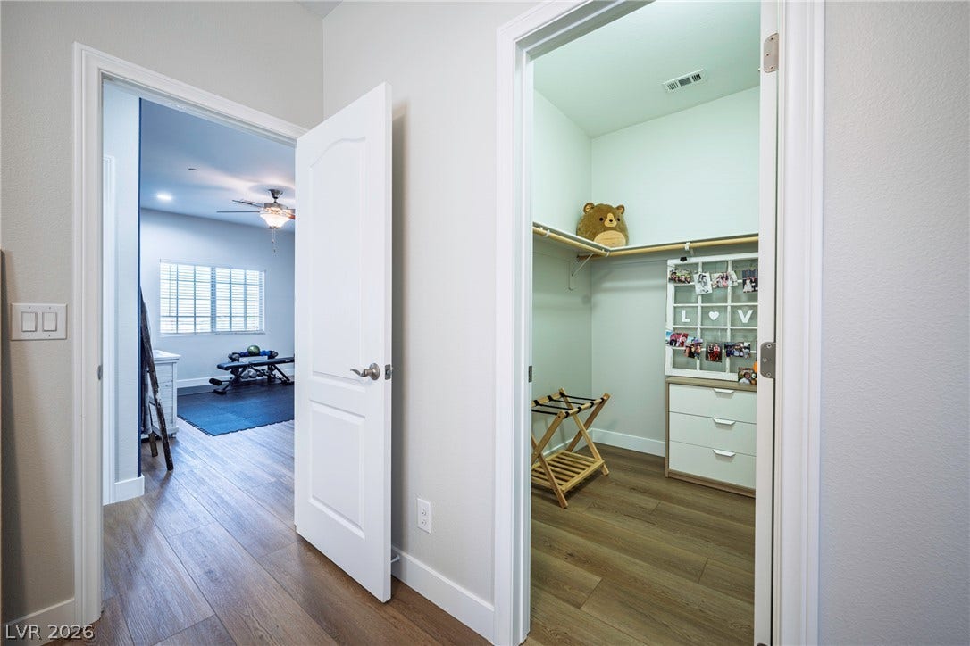 152 Dunblane Street, Henderson, NV 89012 Clean lines and warm wood floors connect the bedroom to a spacious closet.