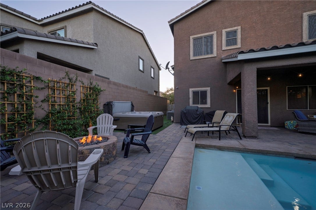 152 Dunblane Street, Henderson, NV 89012 An inviting pool, built-in fire pit, and private spa highlight this stone paver patio.