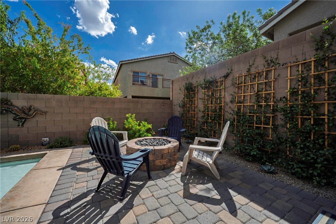 152 Dunblane Street, Henderson, NV 89012 Paver stone patio area features a built-in stone fire pit adjacent to the pool.