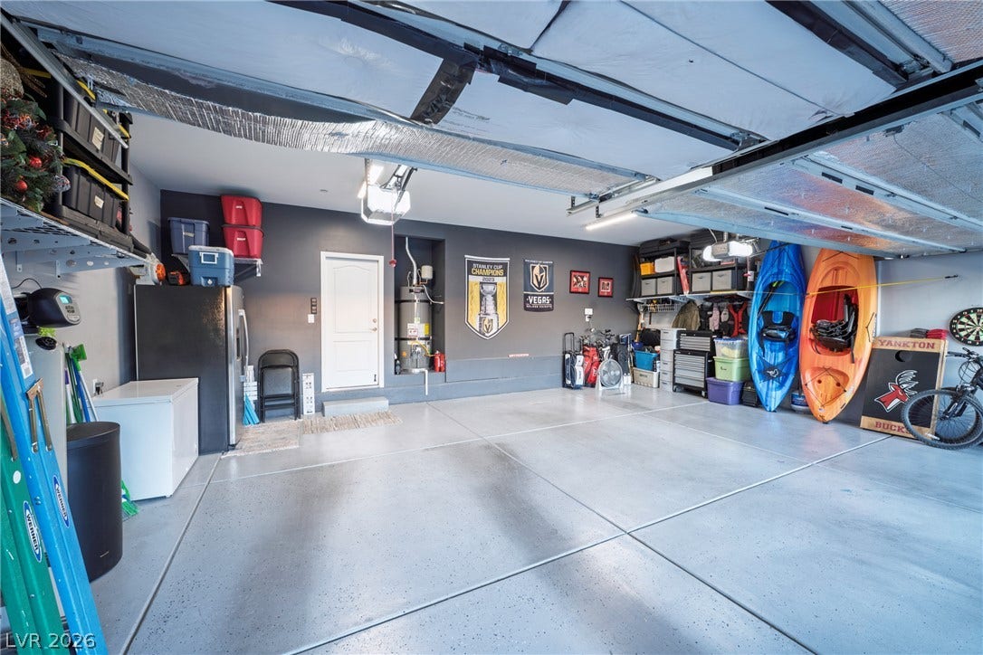 152 Dunblane Street, Henderson, NV 89012 An organized garage features seamless concrete flooring and integrated overhead storage systems.