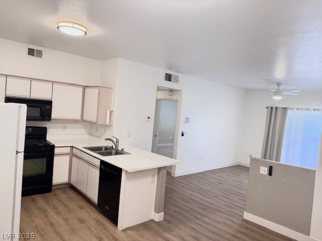 An open floorplan seamlessly connects the functional kitchen space to the adjacent living area.