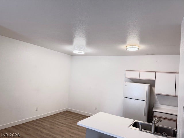 Kitchen & dining Combo layout are Smooth wood-look flooring and crisp white walls define this versatile interior space.