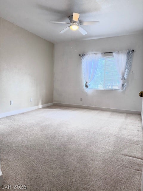 Plush wall-to-wall carpeting and a wide window create a comfortable, inviting bedroom retreat.