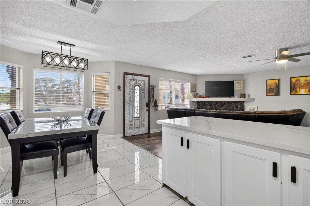 1341 Pinto Rock Lane, #202, Las Vegas, NV 89128 Polished tile flooring and an open layout connect the dining area to the living space.