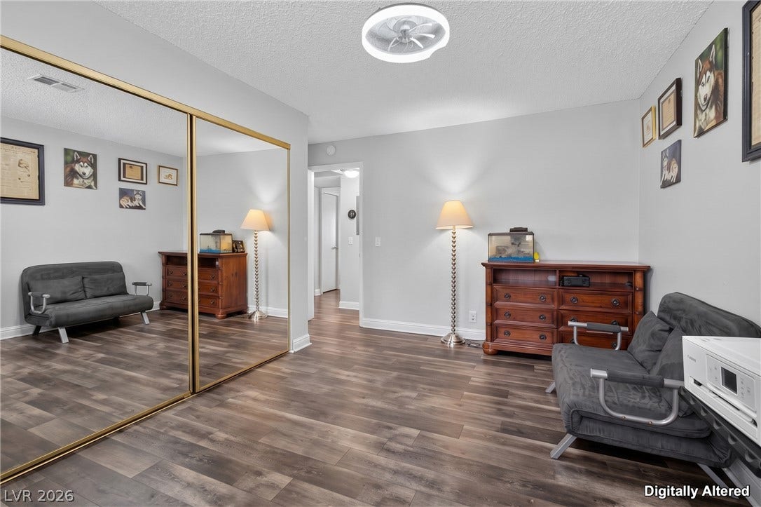 1341 Pinto Rock Lane, #202, Las Vegas, NV 89128 Rich wood-inspired floors and mirrored closets define this versatile secondary space.