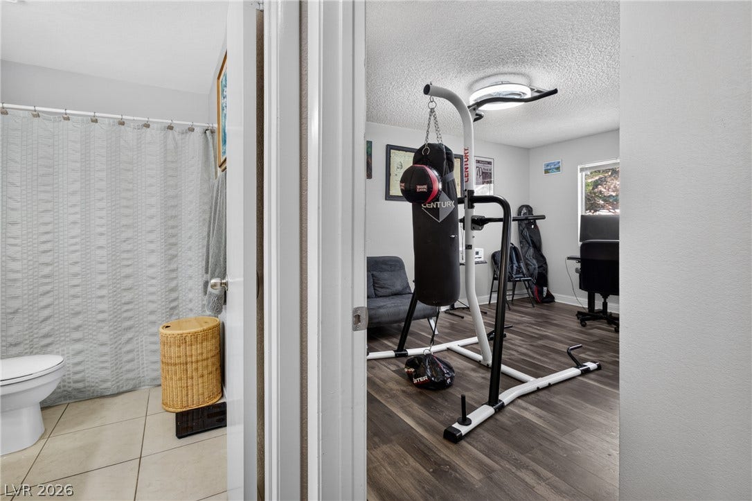 1341 Pinto Rock Lane, #202, Las Vegas, NV 89128 Smooth wood-look flooring connects the versatile bonus room directly to an adjacent tile bathroom.