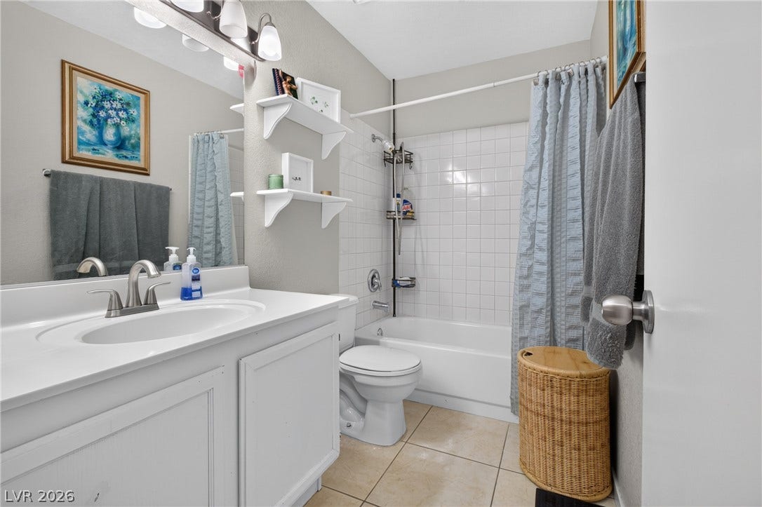 1341 Pinto Rock Lane, #202, Las Vegas, NV 89128 A classic tiled tub shower highlights this functional secondary bathroom layout.