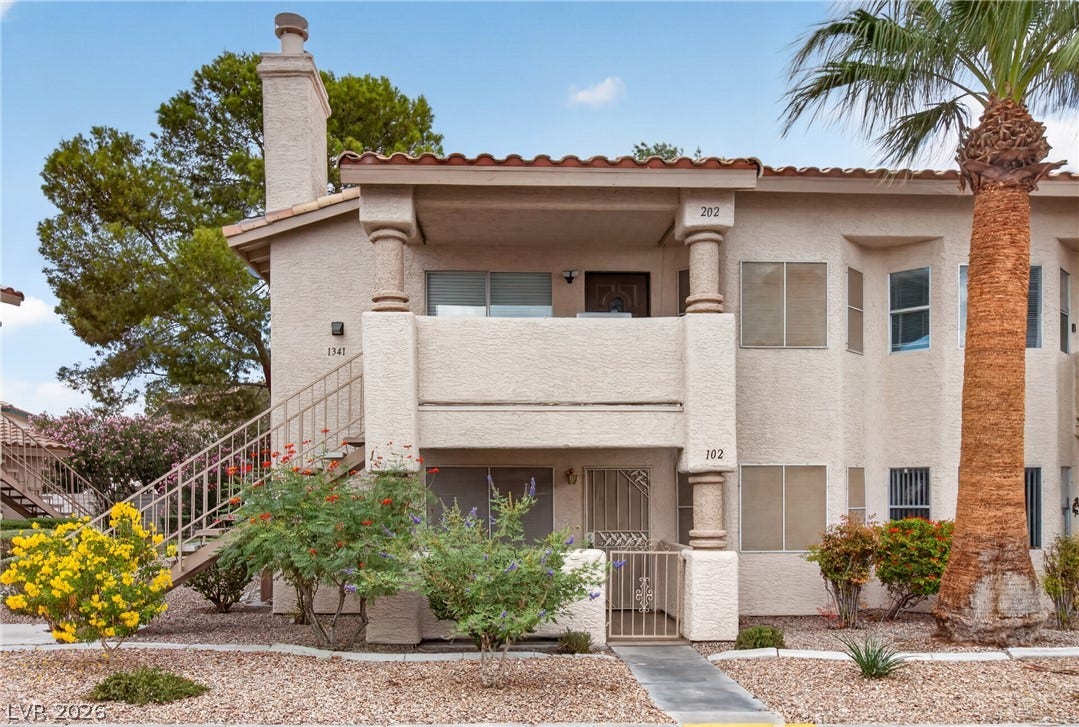 1341 Pinto Rock Lane, #202, Las Vegas, NV 89128 Spanish tile roofs and stucco finishes highlight this classic desert exterior architecture.