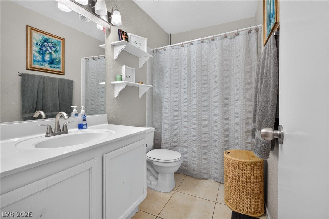 1341 Pinto Rock Lane, #202, Las Vegas, NV 89128 Tiled flooring and built-in shelving maximize the efficiency of this updated guest bathroom.