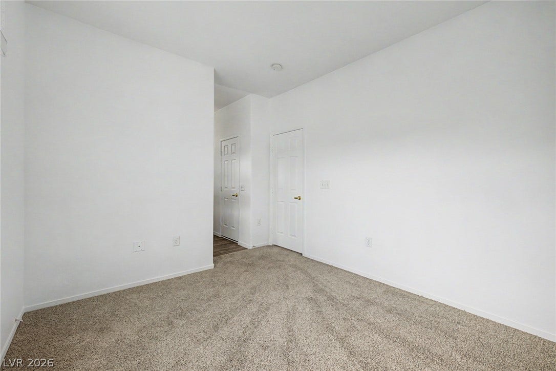 Plush wall-to-wall carpeting and clean lines define this versatile bedroom space.