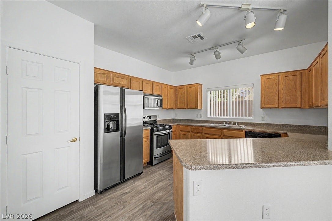 Ample counter space and classic wood cabinetry define this functional, open kitchen layout.