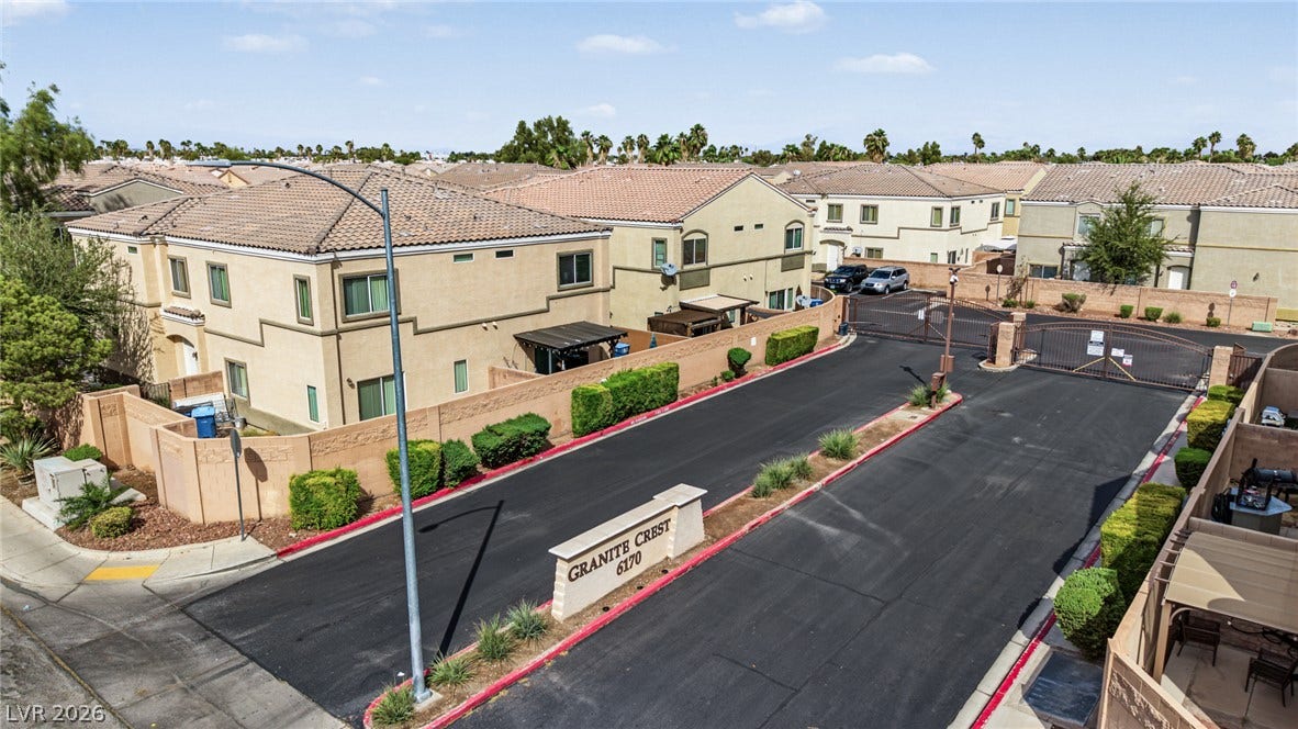 Secure gated entry introduces this charming residential neighborhood lined with tiled roofs and paved streets.