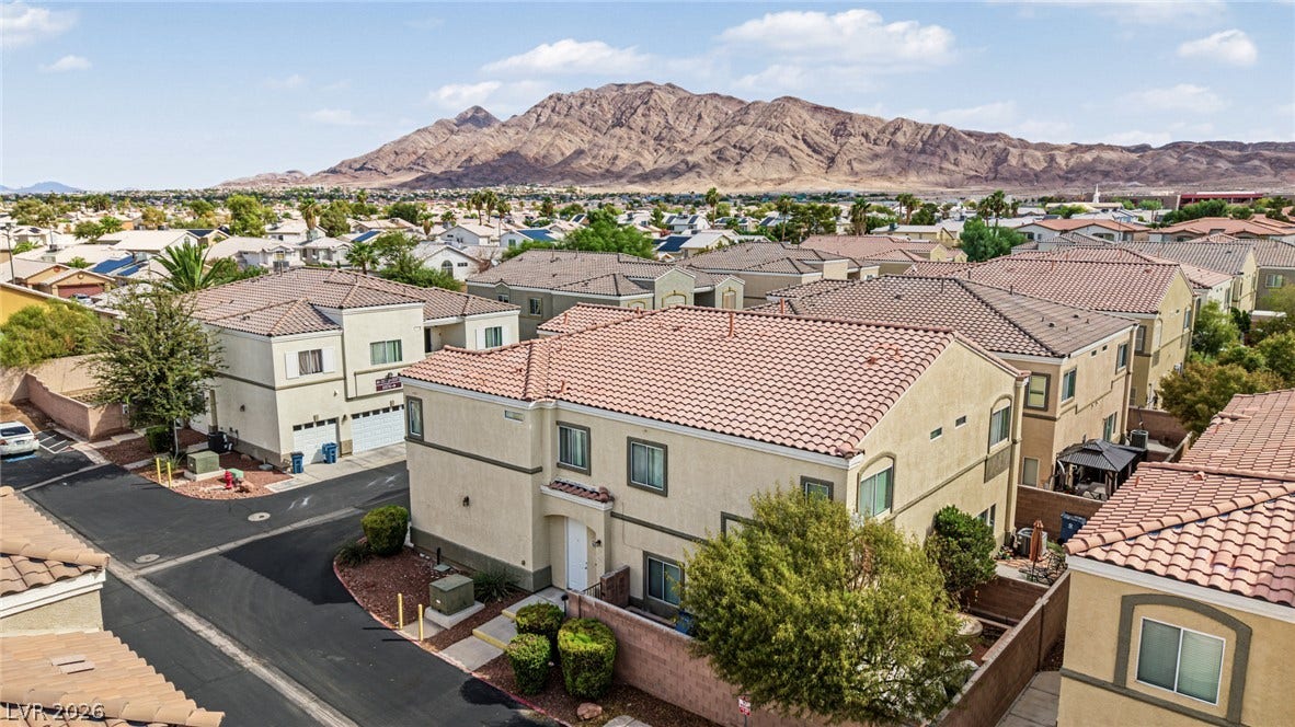 Scenic mountain vistas frame this neighborhood of multi-level residences with tile roofs.