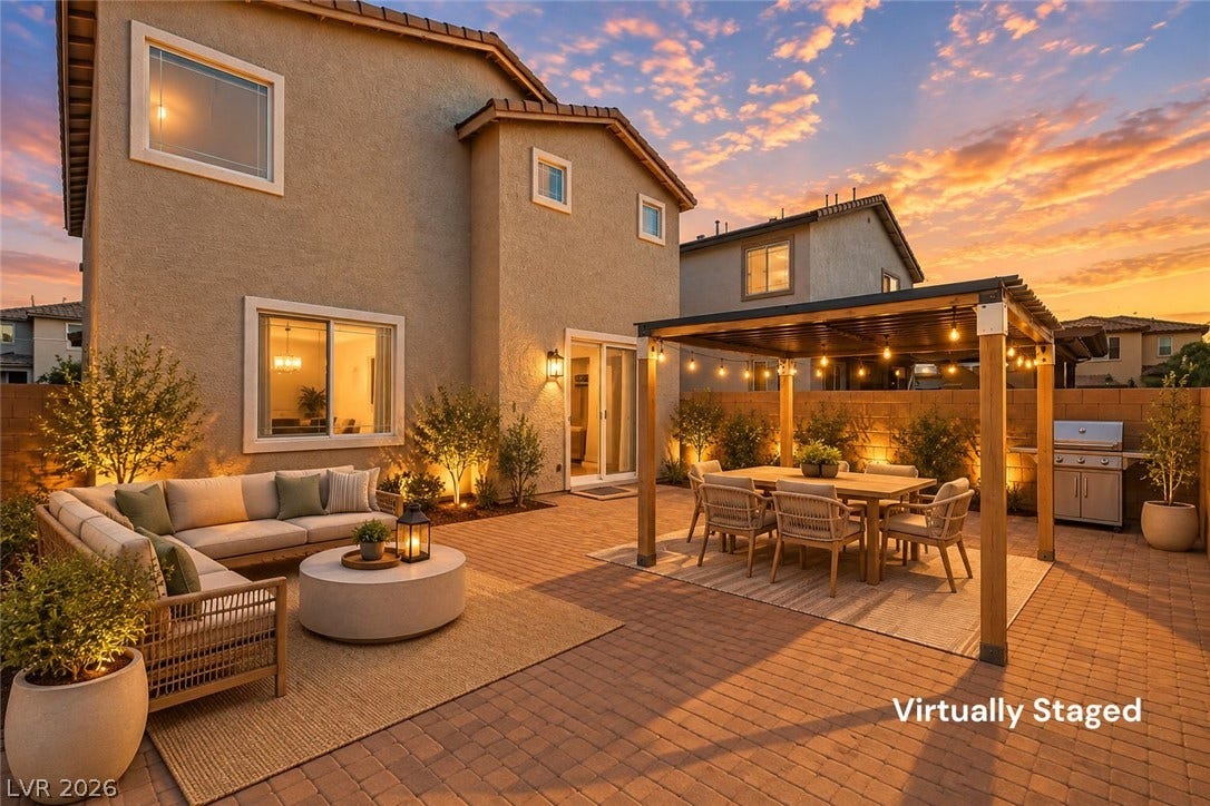 6047 Castle Gardens Avenue, Las Vegas, NV 89130 An inviting paver patio extends into a fenced backyard with a freestanding pergola structure.