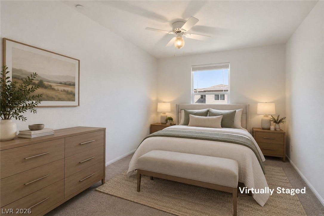 6047 Castle Gardens Avenue, Las Vegas, NV 89130 A quiet bedroom offers soft wall finishes and wall-to-wall carpeting beneath a central window.