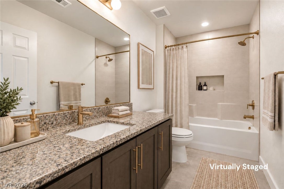 6047 Castle Gardens Avenue, Las Vegas, NV 89130 Polished granite counters and matching gold-toned fixtures elevate this modern full bathroom.