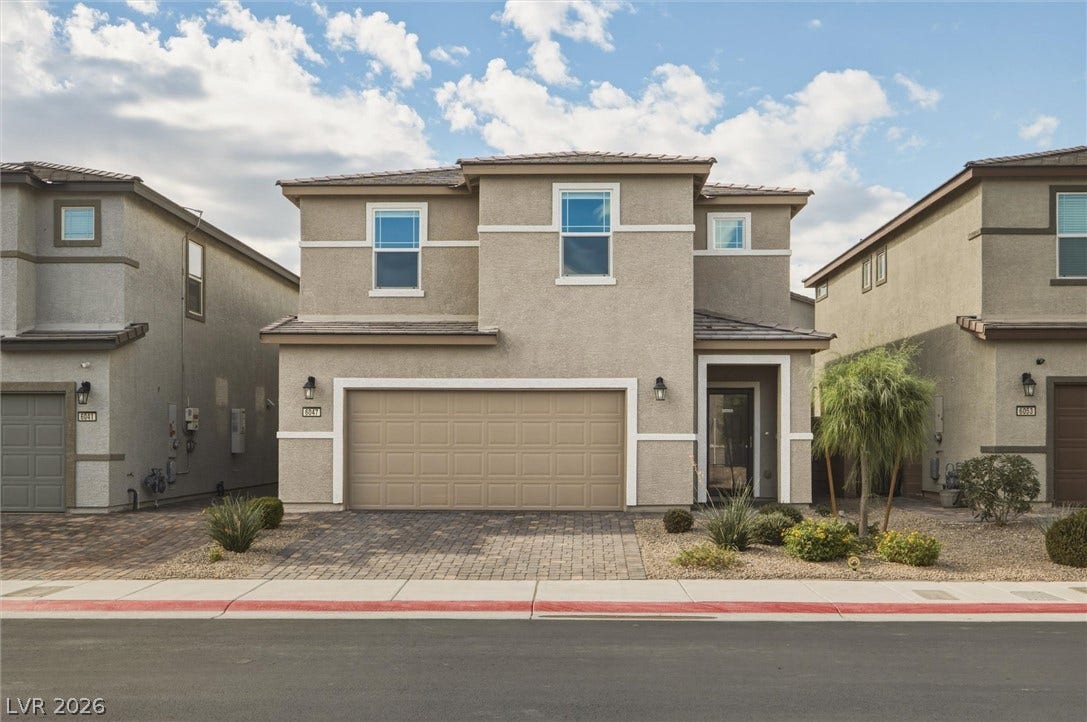 6047 Castle Gardens Avenue, Las Vegas, NV 89130 Clean lines and professional landscaping define this modern two-story exterior.