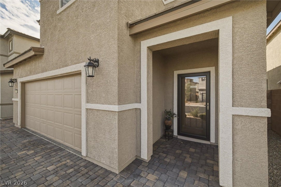 6047 Castle Gardens Avenue, Las Vegas, NV 89130 An inviting recessed entryway and paved driveway welcome guests to this stucco home.