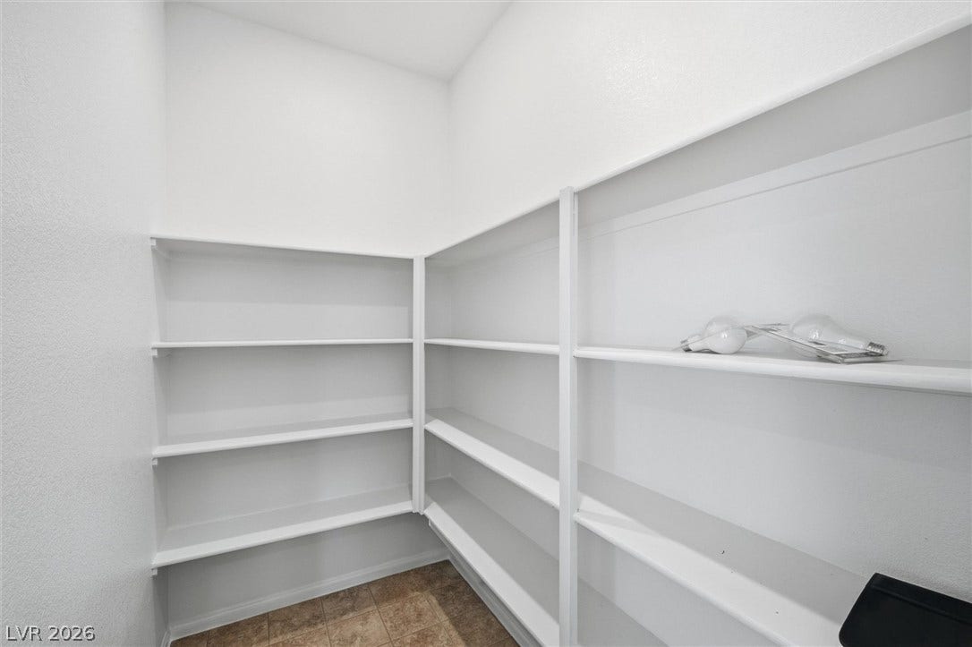 6047 Castle Gardens Avenue, Las Vegas, NV 89130 Generous wrap-around shelving highlights this functional storage pantry.