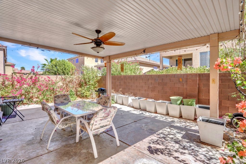 8430 Golden Amber Street, Las Vegas, NV 89139 An inviting covered patio features concrete flooring and opens to a fenced backyard space.