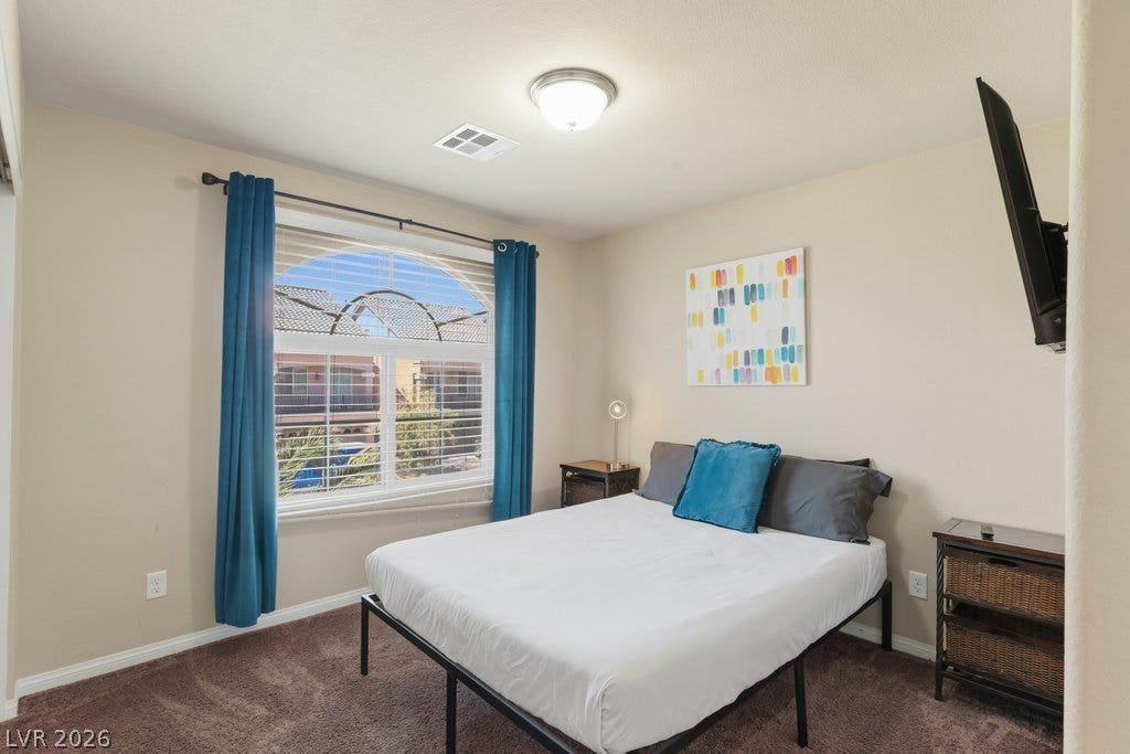 8430 Golden Amber Street, Las Vegas, NV 89139 Plush carpeting and an arched window define this comfortable private retreat.