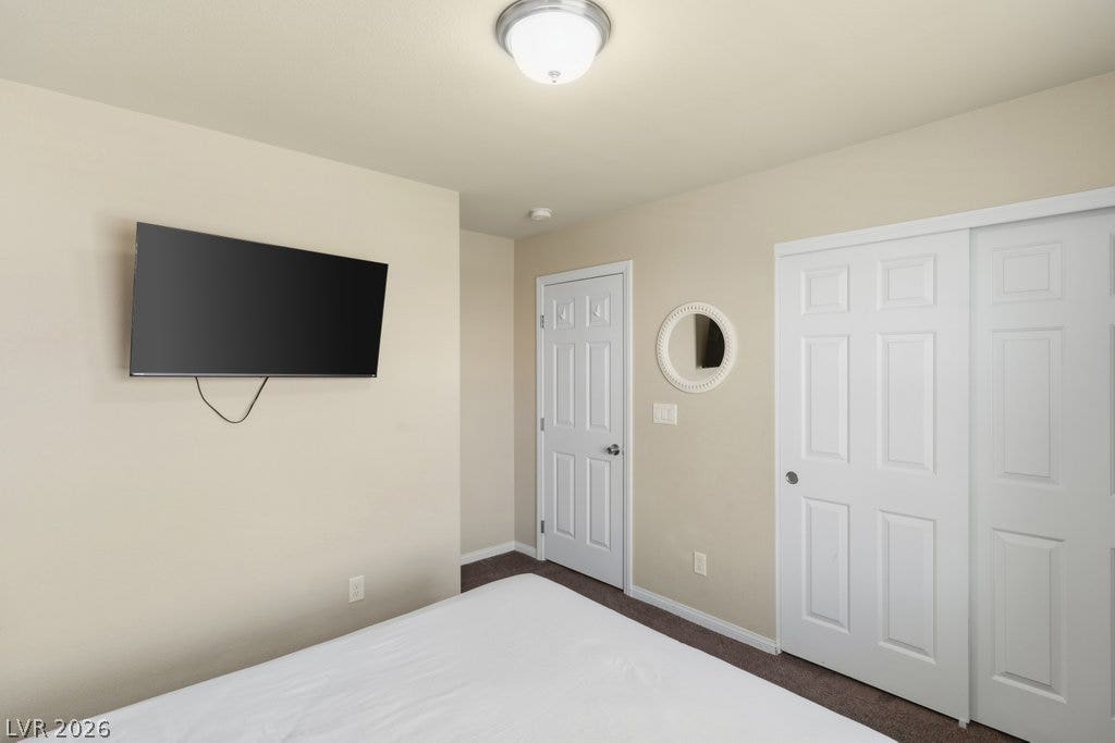 8430 Golden Amber Street, Las Vegas, NV 89139 Soft carpeting and neutral walls define this comfortable bedroom space.