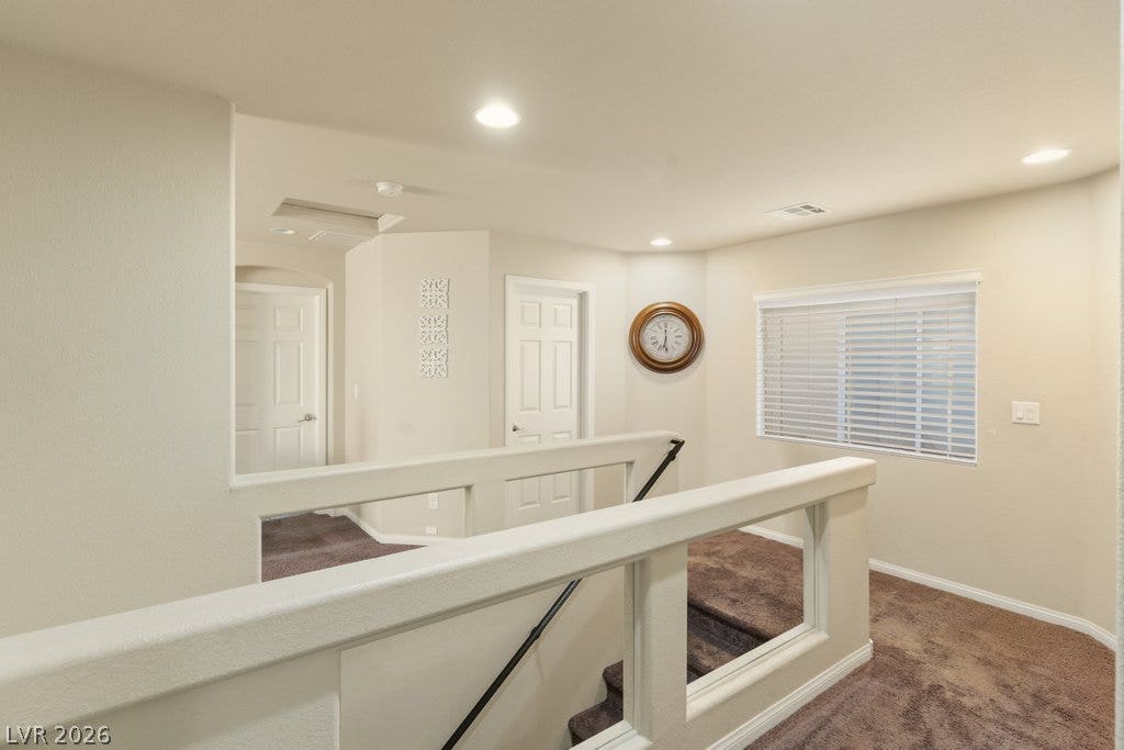 8430 Golden Amber Street, Las Vegas, NV 89139 Recessed lighting and plush carpet warm this upper-level landing overlooking the staircase.