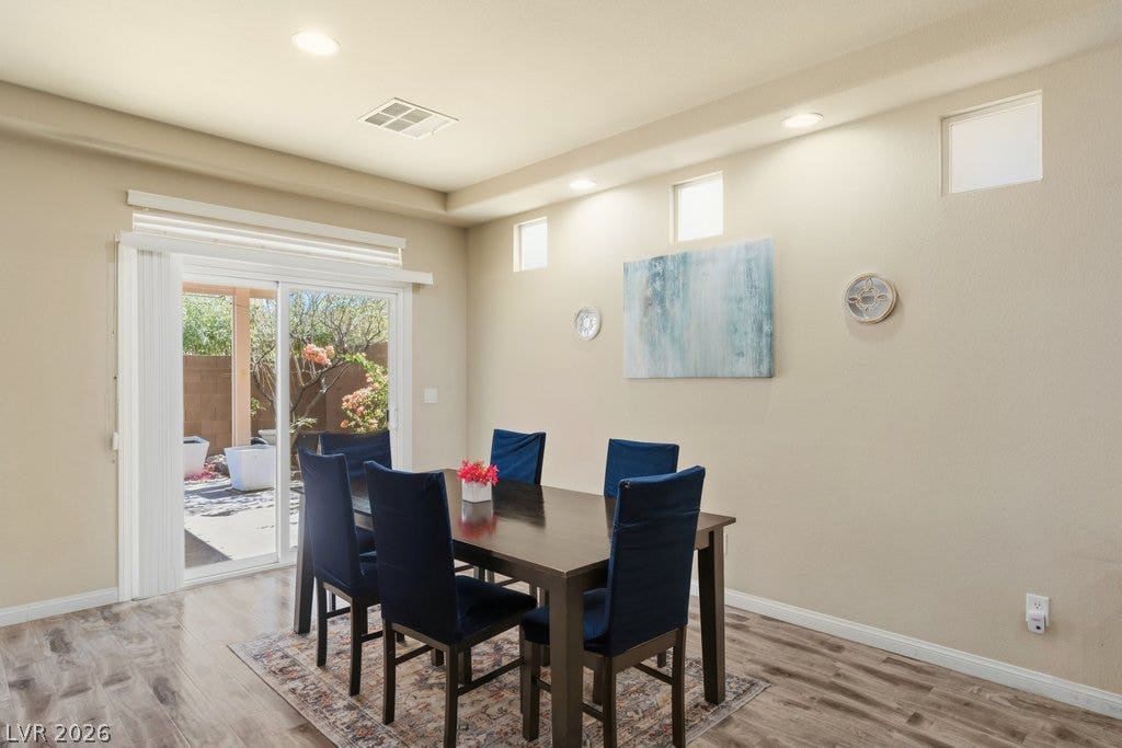 8430 Golden Amber Street, Las Vegas, NV 89139 Sliding glass doors open from the dining area to a private outdoor patio space.