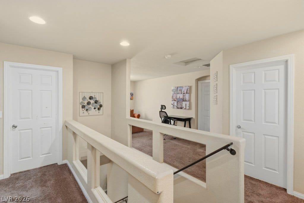 8430 Golden Amber Street, Las Vegas, NV 89139 A spacious upper-level landing connects separate rooms with warm wall-to-wall carpeting and recessed lighting.