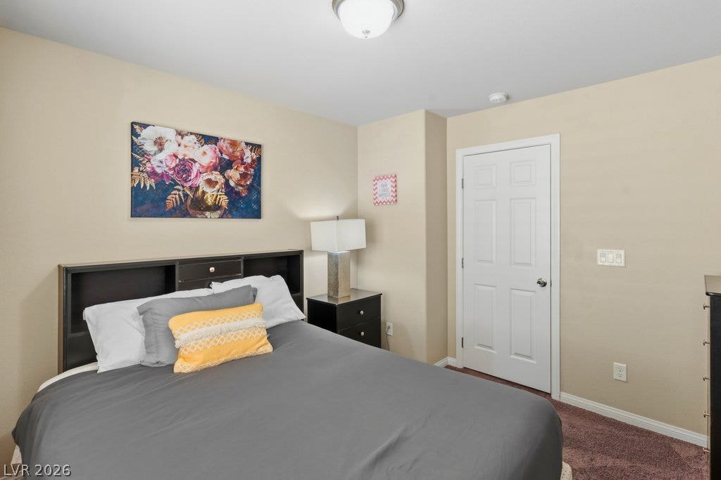 8430 Golden Amber Street, Las Vegas, NV 89139 Plush carpeting and a neutral color palette define this quiet bedroom retreat.