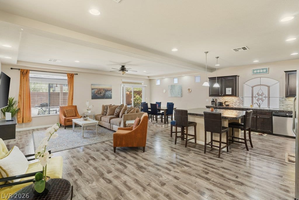 8430 Golden Amber Street, Las Vegas, NV 89139 Polished hard surface flooring sweeps through this expansive, light-filled open-concept living space.