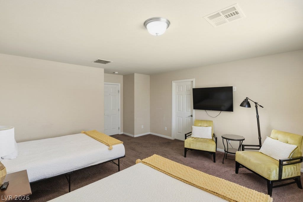8430 Golden Amber Street, Las Vegas, NV 89139 Plush carpeting and neutrally toned walls maximize comfort in this versatile secondary bedroom.