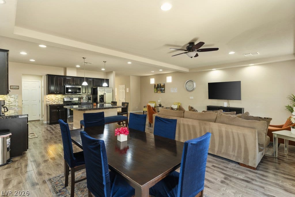 8430 Golden Amber Street, Las Vegas, NV 89139 An open floorplan seamlessly connects the dining area to a spacious living room and kitchen.