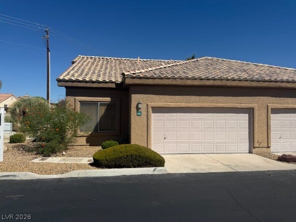Stucco exterior finishes and a tile roof define this classic desert-style townhouse architecture.