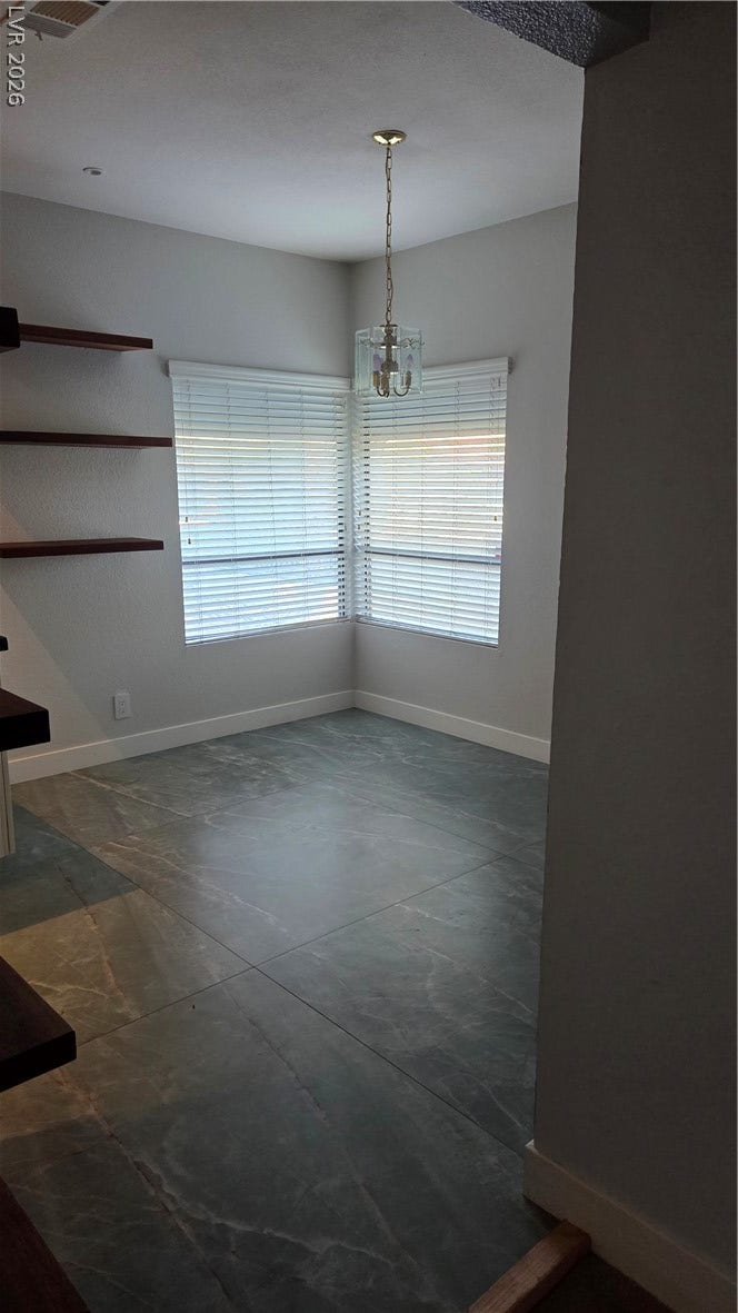 2619 Red Rock Street, #101, Las Vegas, NV 89146 Gleaming oversized tile floors and corner windows define this versatile dining space.