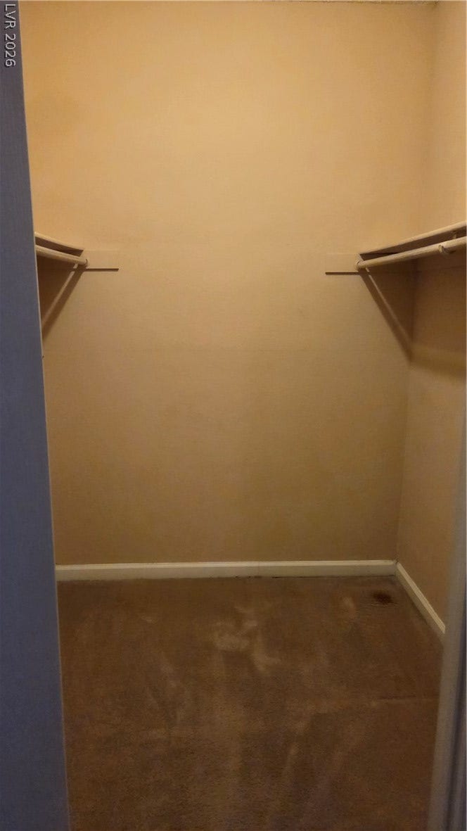 2619 Red Rock Street, #101, Las Vegas, NV 89146 Ample closet space features wall-mounted hanging rods and soft carpeting.