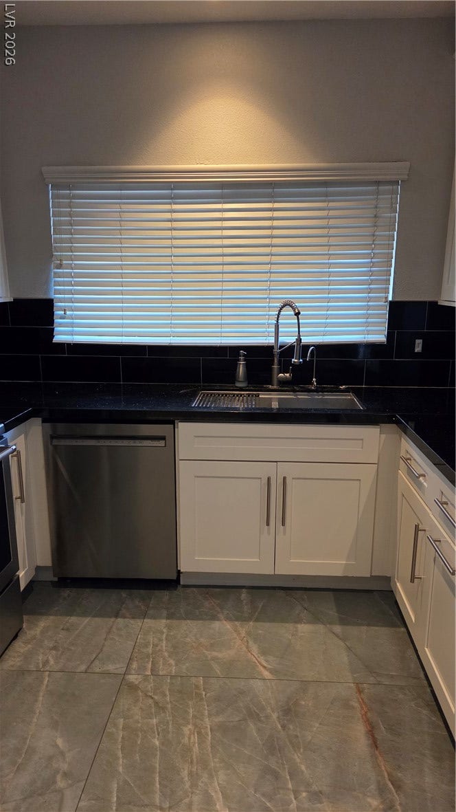 2619 Red Rock Street, #101, Las Vegas, NV 89146 Granite countertops and clean white cabinetry ground this functional kitchen workspace.