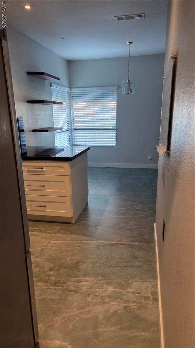 2619 Red Rock Street, #101, Las Vegas, NV 89146 Large-format tile floors run from the entry through to a sunny window-lit breakfast area.