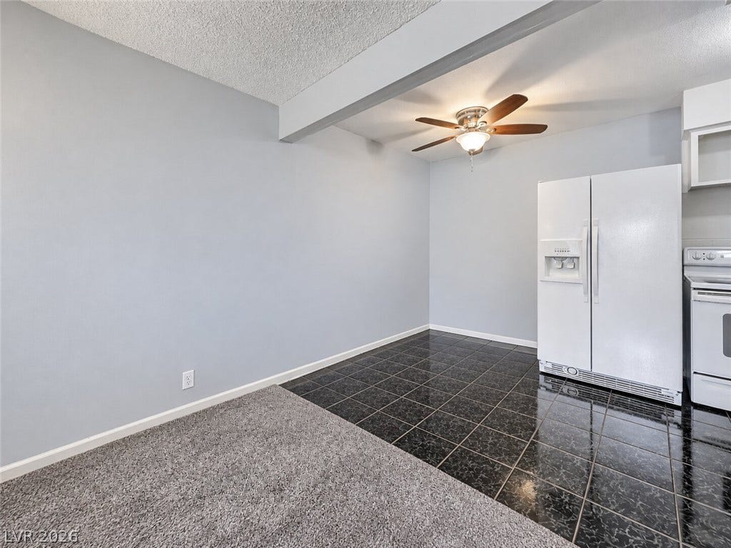 615 S Royal Crest Circle, #16, Las Vegas, NV 89169 Gleaming dark tile transitions to soft carpet in this versatile dining area.