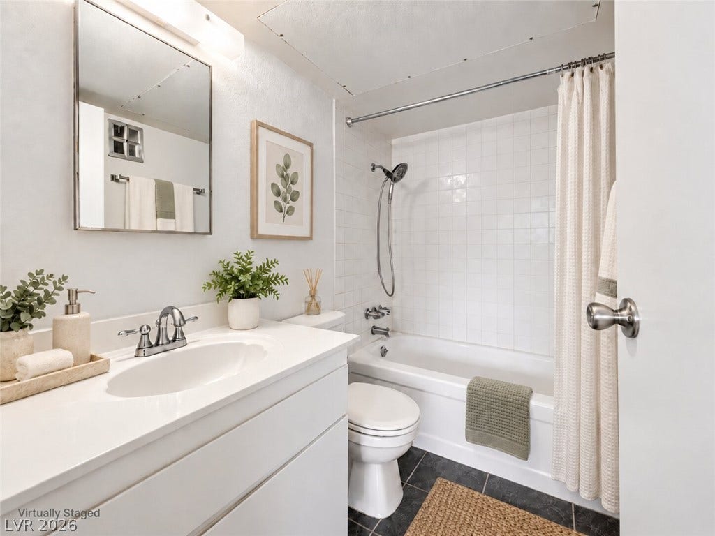 615 S Royal Crest Circle, #16, Las Vegas, NV 89169 Crisp white wall tile surrounds the shower-tub combination in this updated bathroom.