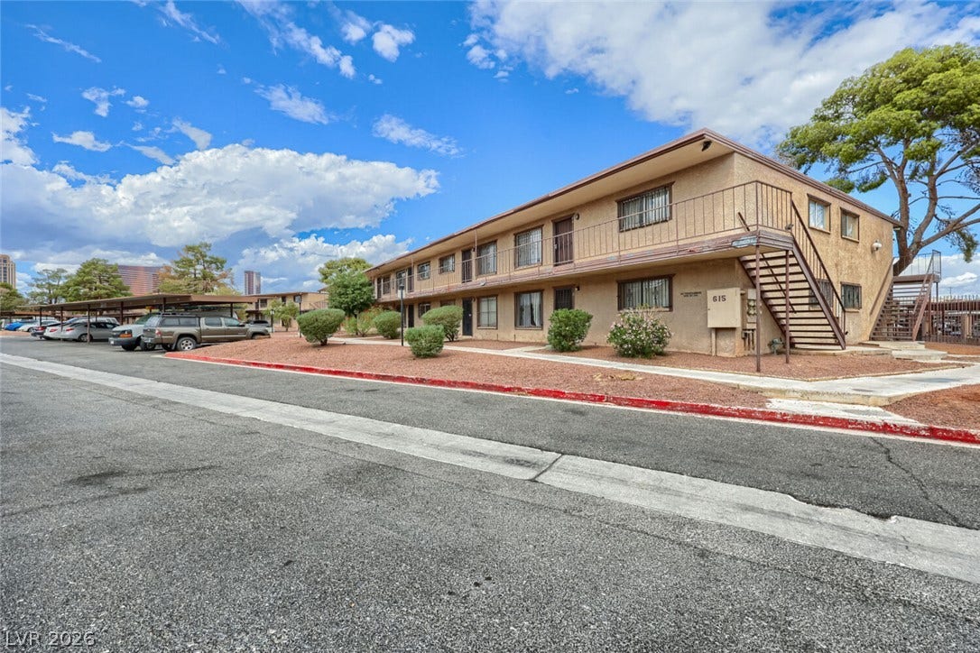 615 S Royal Crest Circle, #16, Las Vegas, NV 89169 Stucco exterior finishes and external metal staircases define this multi-level residential structure.