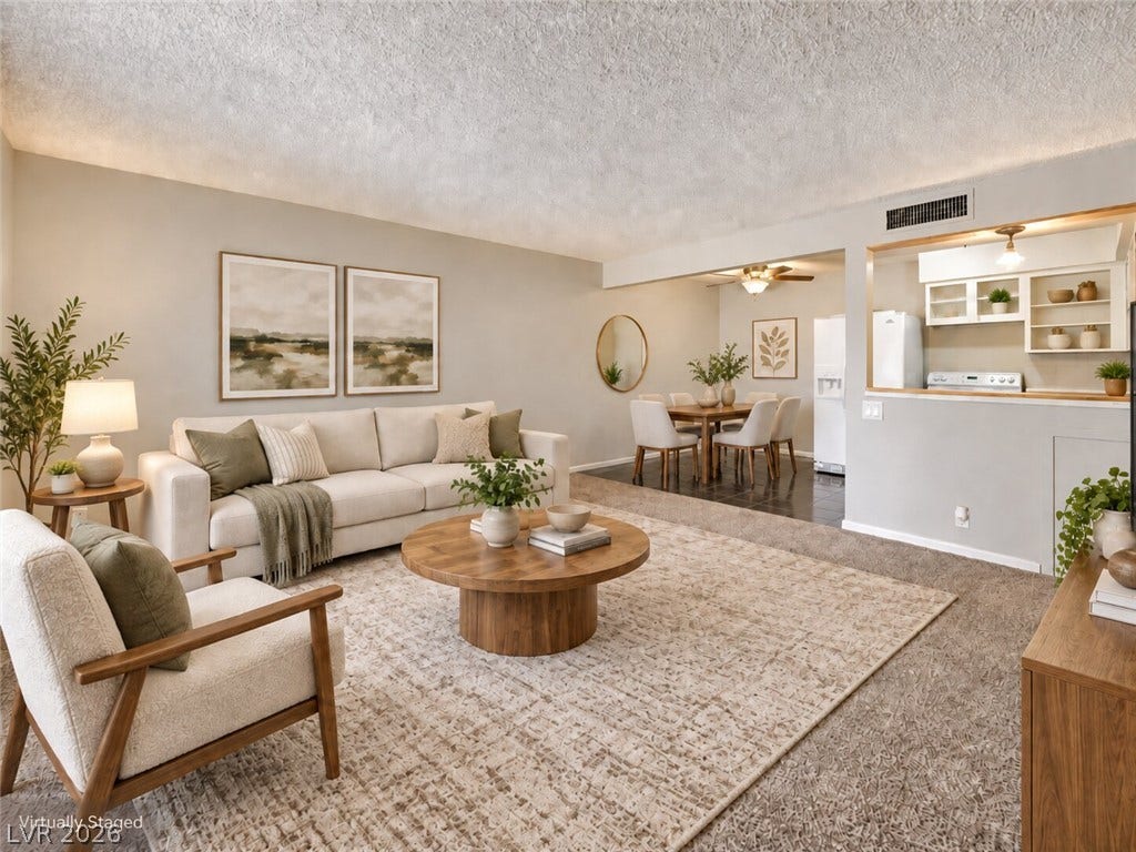 615 S Royal Crest Circle, #16, Las Vegas, NV 89169 An open living room leads seamlessly to an adjacent dining area and kitchen pass-through.