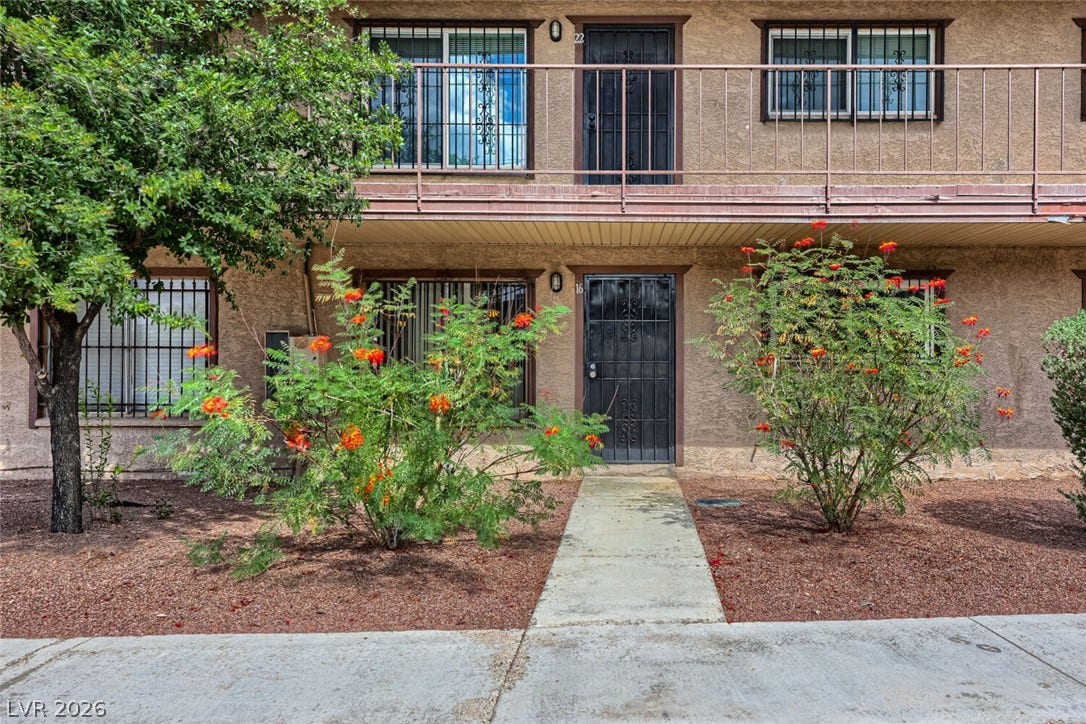 615 S Royal Crest Circle, #16, Las Vegas, NV 89169 A concrete walkway leads to the private entrance of this multi-level stucco residence.