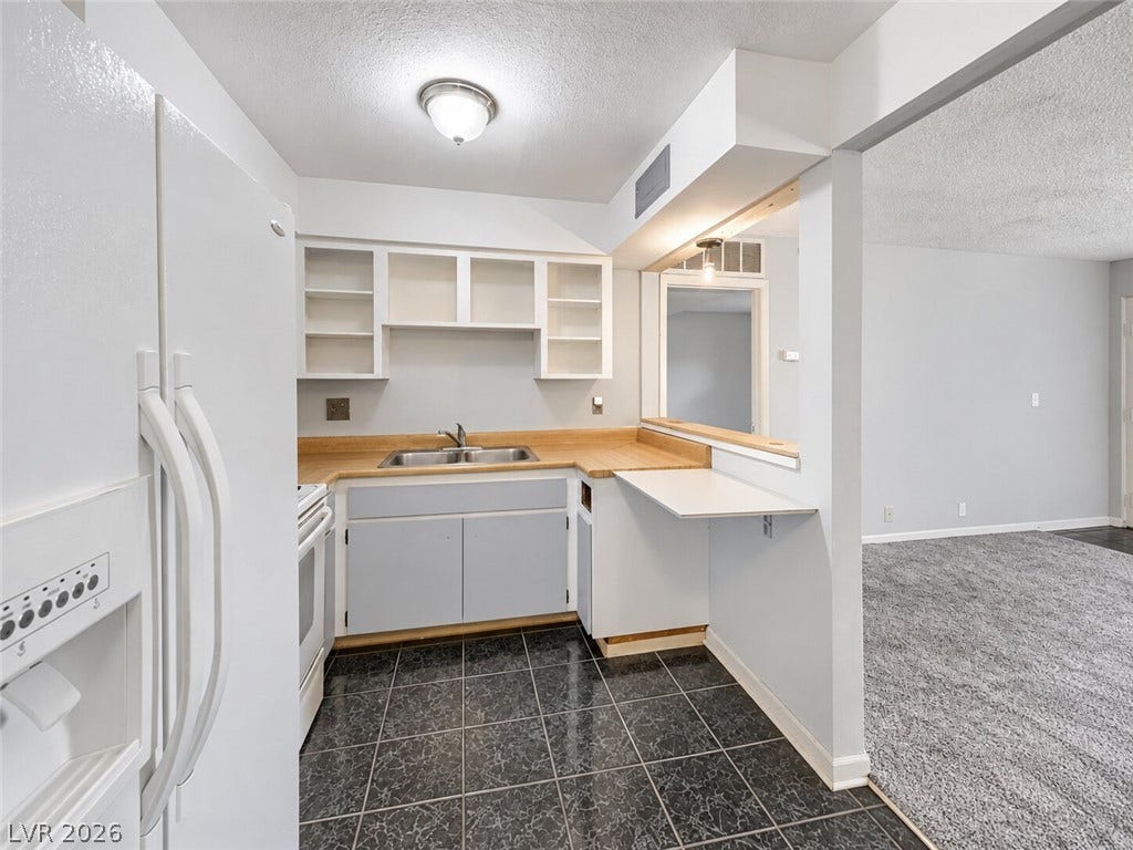 615 S Royal Crest Circle, #16, Las Vegas, NV 89169 A breakfast bar opens the kitchen to the adjacent living area.