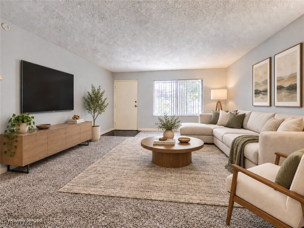 615 S Royal Crest Circle, #16, Las Vegas, NV 89169 A spacious living room features wall-to-wall carpeting and a wide window looking outside.