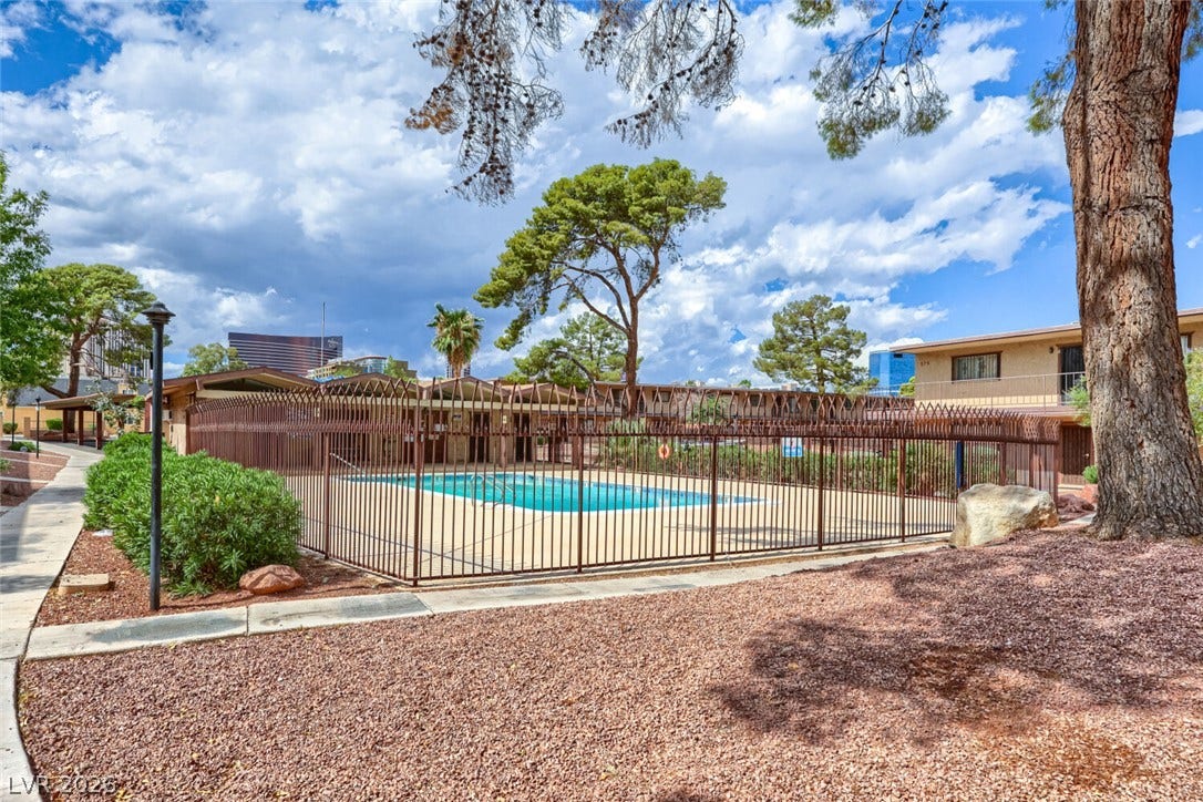 615 S Royal Crest Circle, #16, Las Vegas, NV 89169 Mature trees and a secure metal fence surround this sparkling community swimming pool.