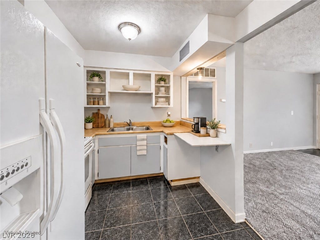 615 S Royal Crest Circle, #16, Las Vegas, NV 89169 An open pass-through breakfast bar connects this efficient kitchen to the adjoining living space.