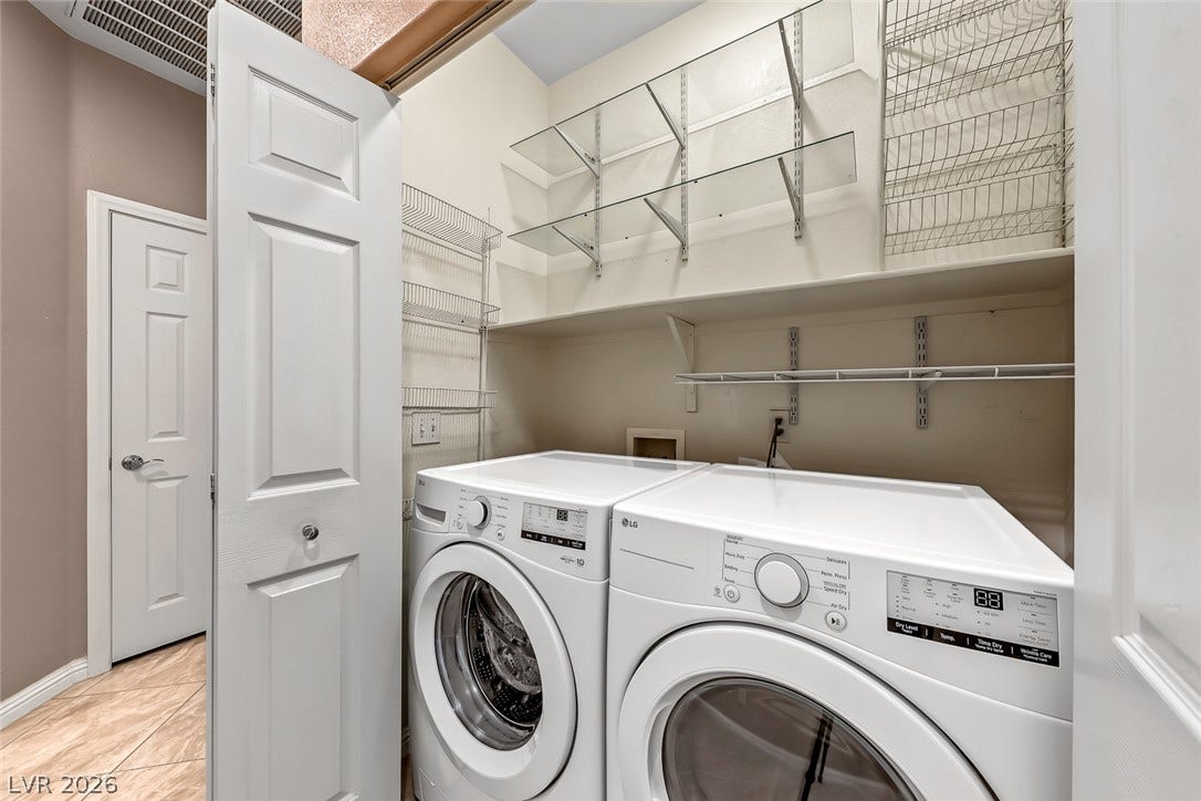 2906 Pumpkin Harvest Avenue, North Las Vegas, NV 89031 A dedicated laundry closet offers convenient storage shelves above the front-loading appliances.